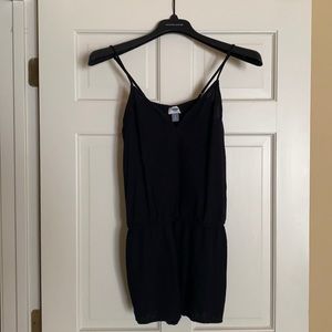 Black romper with embroidered detail.